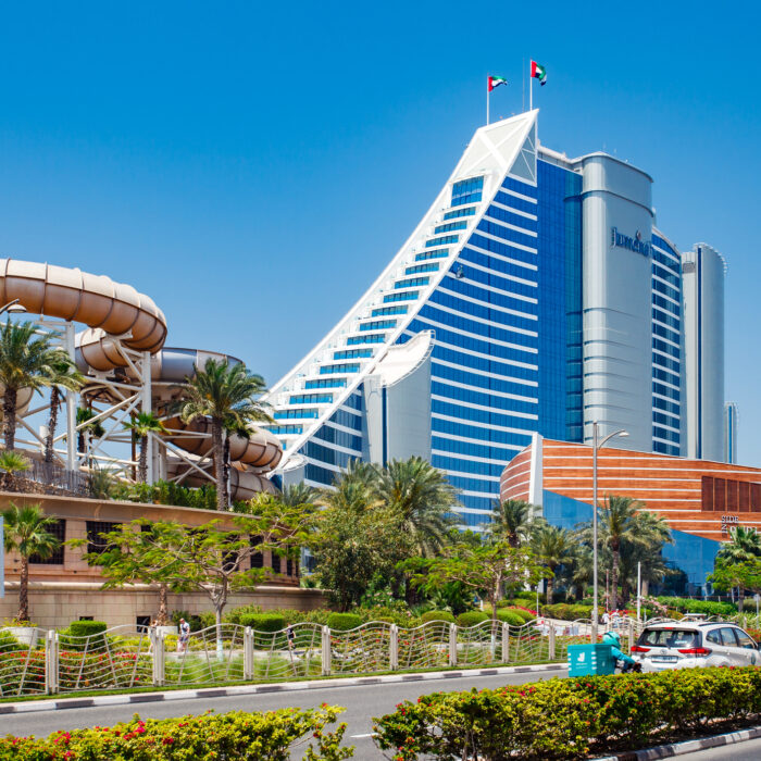 Dubai, UAE  april 10, 2023: Jumeirah Beach Hotel, eastern part at clear day, cars on the road, Wild Wadi Waterpark Dubai
