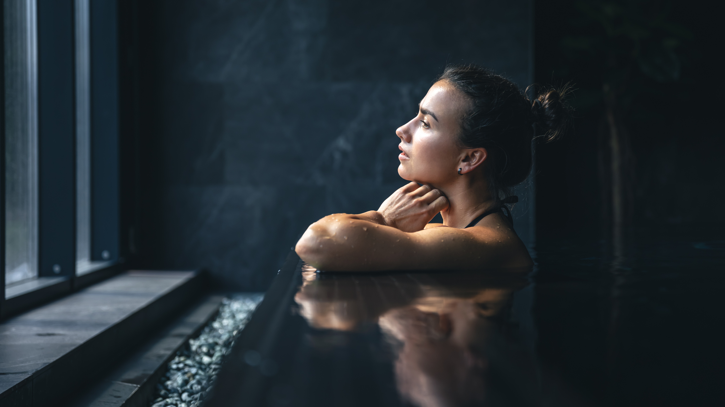 Woman relaxing in the pool in the luxury spa